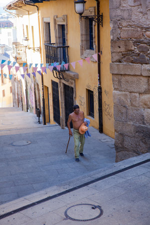PONFERRADA, SPAIN - AUGUST, 06: Senior without shirt walking in the town on August 06, 2016のeditorial素材