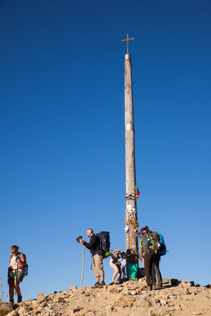 FONCEBADON, SPAIN - AUGUST, 05: Pilgrimns next to the iron cross called cruz de Hierro along the way...