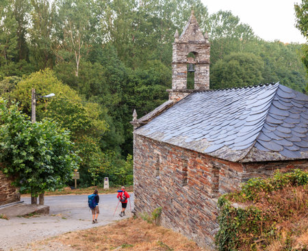Pilgrimns next to the church along the way of St. James, Spainのeditorial素材