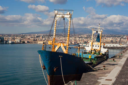 Old fisherboat docked in the Catania pierの写真素材