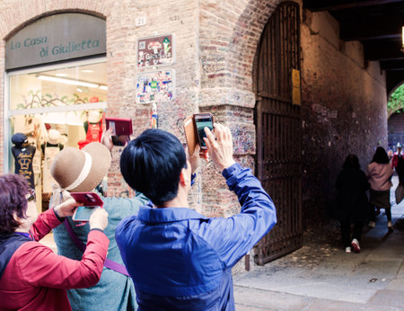 VERONA, ITALY - APRIL, 07: Chinese tourists take photos in Verona on April 07, 2017のeditorial素材