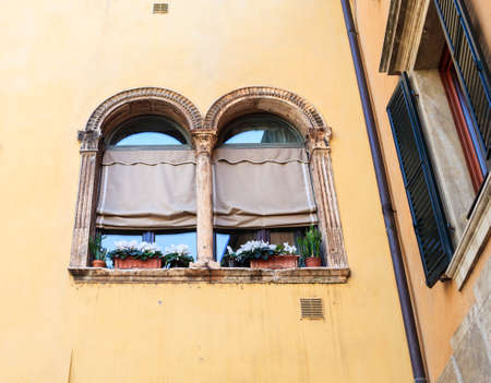 Typical double-arched window, mullioned window in Veronaの写真素材