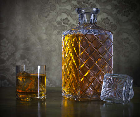 Whiskey in a nice bottle and glass with iceの写真素材