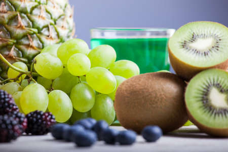 Close up of grape and kiwi on wooden tableの写真素材