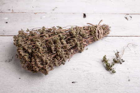 Close up of dried oregano herb on white tableの写真素材