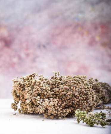 Close up of dried oregano herb on white tableの写真素材