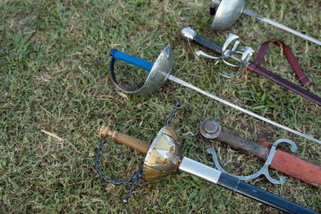 Swords and sabers on grass during the historical Reenactment in Palmanovaの写真素材