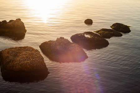 Rock on the sea at sunset in Ortigia, Syracuseの写真素材