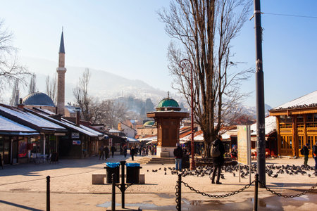 SARAJEVO, BOSNIA-ERZEGOVINA - FEBRUARY, 16:View of the Sebilj wooden fountain and Bascarsijska Dzamija minaret in Bascarsija square on February 16, 2018のeditorial素材
