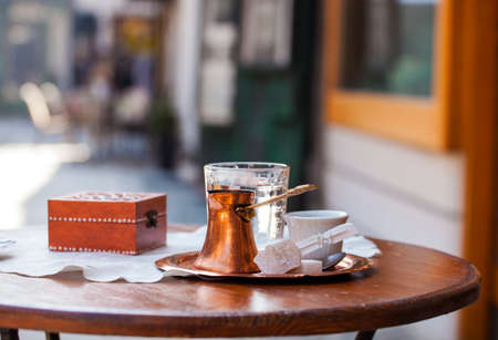 Traditional bosnian coffee served with traditional delights in a coffee house の写真素材