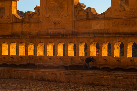 LEONFORTE, ITALY - DECEMBER, 28: Child drinking water from Granfonte fountain on December 28, 2017のeditorial素材