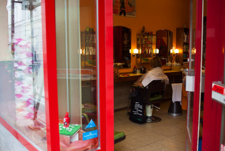 VIENNA, AUSTRIA - MAY, 22: Woman sitting in a barbers' chairs waiting hairdresser in a hairdressing salon on May 22, 2018のeditorial素材
