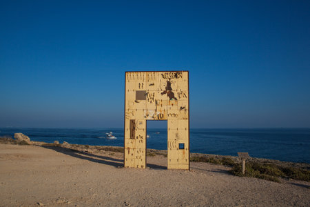 LAMPEDUSA, ITALY - AUGUST, 03: Sculpture of an open door greets the sea realised by the italian artist Mimmo Paladino. Itâs called La Porta dâEuropa - the door of Europe  on August 03, 2018のeditorial素材