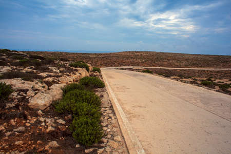 Road in the Lampedusa countryside in the summer season, Sicilyの写真素材
