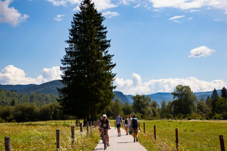 BOHINJ, SLOVENIA - AUGUST, 04: Friends on cycle ride in countryside track in Bohinj on August 04, 2019のeditorial素材