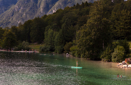 BOHINJ, SLOVENIA - AUGUST, 03: Girl on paddle board in the Bohinj lake on August 03, 2019のeditorial素材