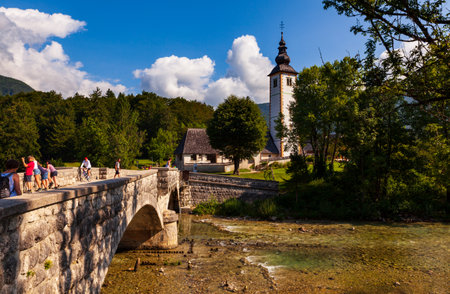 BOHINJ, SLOVENIA - AUGUST, 01: View of Bohinj lake with St John the Baptist church and bridge on August 01, 2019のeditorial素材