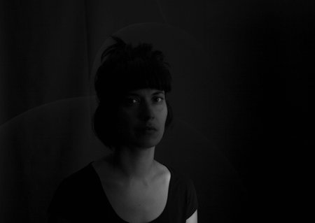 Dramatic portrait of an indian girl on black background