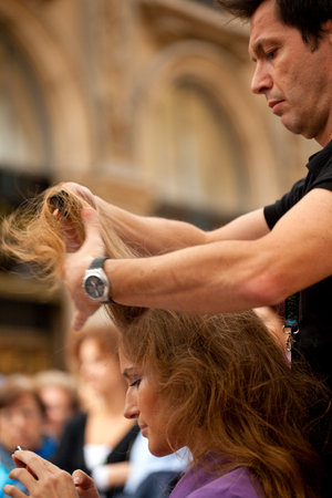 Milan, Italy - September, 26: Hairdresser cutting woman's hair on September 26, 2010のeditorial素材
