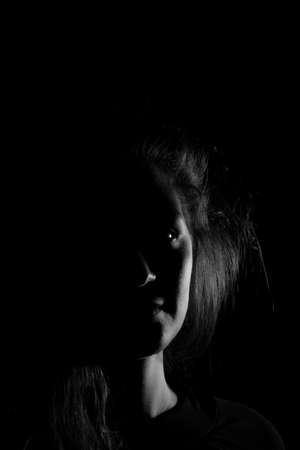 Black and white portrait of an Italian young woman on black backgroundの写真素材