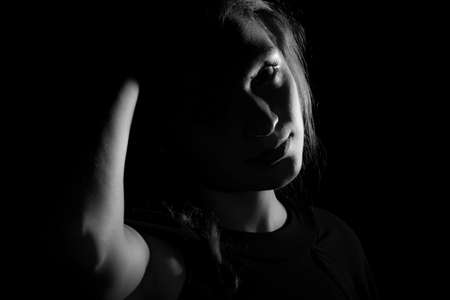 Black and white portrait of an Italian young woman on black backgroundの写真素材