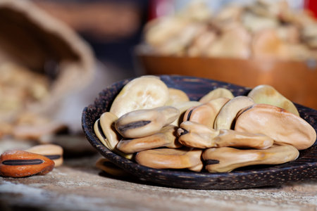 Close up of dried broad beans, and weight scale in a wooden table