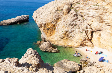 Stara Baska, Croatia - July, 22: Family relaxing in the Stara Baska beach during the summer season on July 22, 2020のeditorial素材