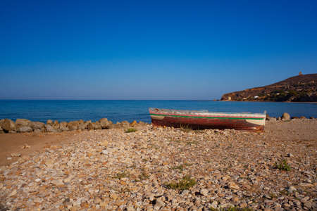 A Broken migrant boat stranded on the beach of the Agrigento coastの写真素材