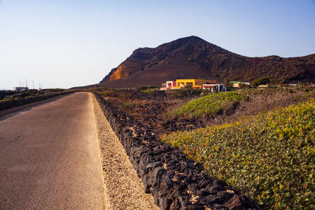 Road with dry stone wall. The Monte Nero Volcano on the background. Linosa, Sicilyの写真素材