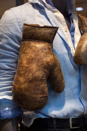 Old Boxing gloves on the male shirtの写真素材