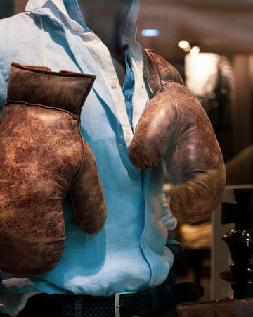 Old Boxing gloves on the male shirtの写真素材