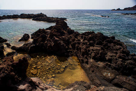 View of the scenic lava rock cliff in the Linosa island. Sicilyの写真素材