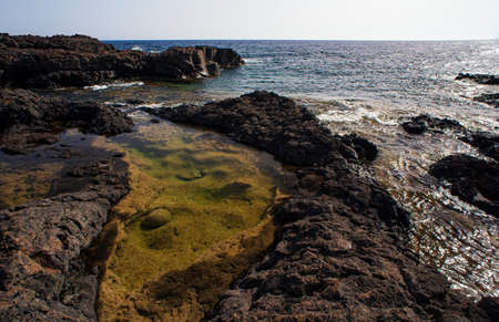 View of the scenic lava rock cliff in the Linosa island. Sicilyの写真素材