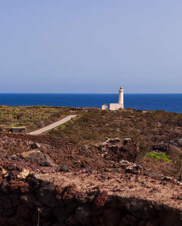 View of lighthouse in the scenic lava rock cliff, Linosa island. Sicilyの写真素材