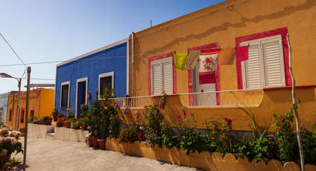 View of a typical colorful houses of Linosa, colored with blue red and orange, Sicily. Italyの写真素材