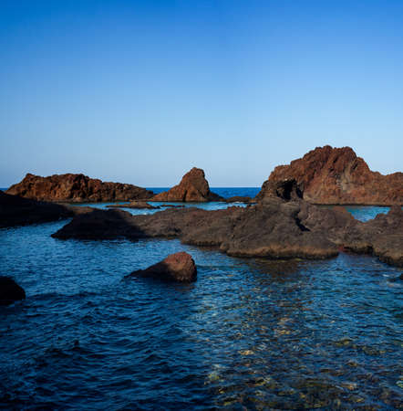 View of the lava beach of Linosa Called Faraglioni, Sicily. Italyの写真素材