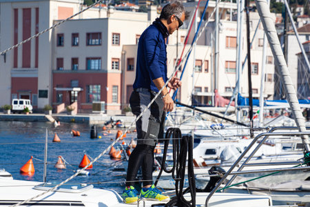 Trieste, Italy - October, 09: Component of the crew of sailboat arrange the tops of the sails during the 53 Â° Barcolana regatta in Trieste sea on October 09, 2021のeditorial素材