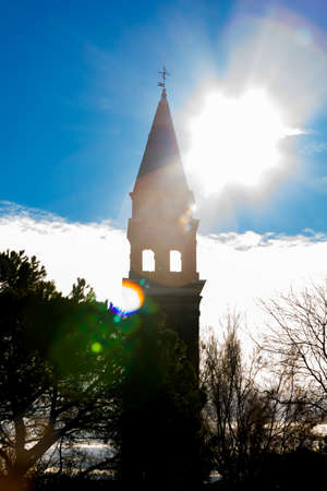 Flare lights on the San Michele Arcangelo bell tower of Mazzorbo, Veniceの写真素材