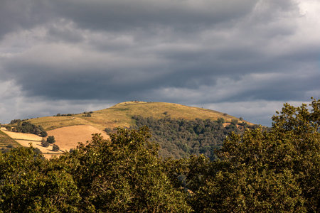 Top view of the french hills on the cloudy sky. Nature scenery along the Chemin du Puy. Way of Saint...