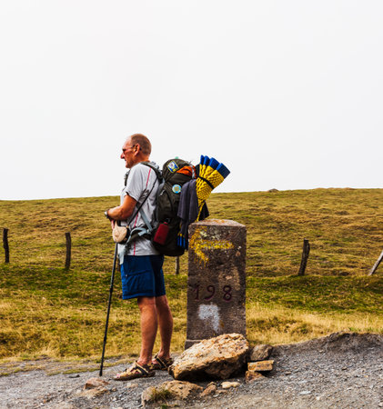 French Pyrenees, France - July 28, 2022: Pilgrim from behind along the Camino de Santiago. Path of the way of St James in the French Pyreneesのeditorial素材