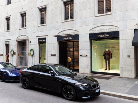 Milan, Italy - October 16, 2022: BMW car parked next to the Prada store in Montenapoleone, Milan is a luxury fashion destination for the latest high-end fashion. The store offers clothing, shoes, and accessories from the renowned designer brandのeditorial素材