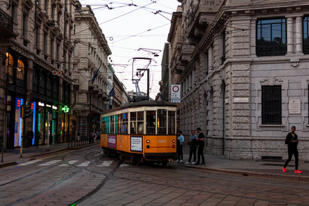 Milan, Italy - October 22, 2022: View of the old vintage orange tram on the street of Milan, Italyの写真素材