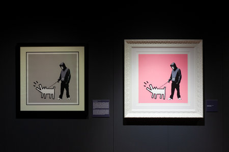 Trieste, Italy - January 21, 2023: Screen prints Choose your weapon, pink and silver by Banksy. Exposition titled The Great Communicator Banksy, Hall of Enchantments. Courtesy Deodato Galleryのeditorial素材
