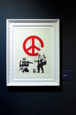 Trieste, Italy - January 21, 2023: Screen print titled CND Soldiers by Banksy. The Great Communicator Banksy, Hall of Enchantmentsのeditorial素材