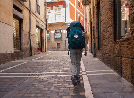 Pilgrim walking in Pamplona's street along the Way to Santiago de Compostela on the St James pilgrimage route, Spainのeditorial素材