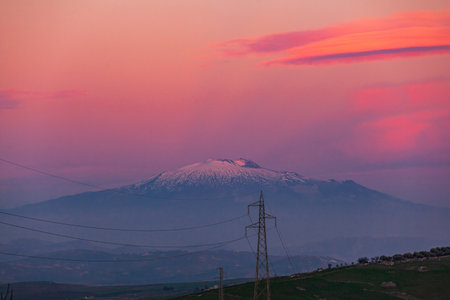 The majestic Etna volcano at sunset seen from central Sicily on pink skyの写真素材