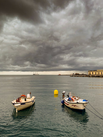 boats. Trieste Seafront with cloudy sky in the winter seasonの写真素材