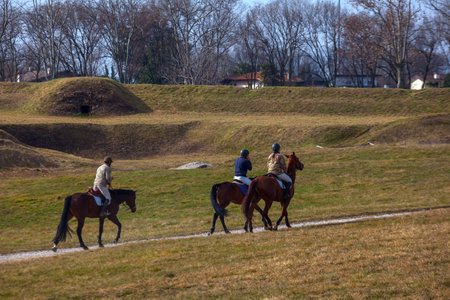 Horseback riders gracefully explore Palmanova's bastions, blending equestrian adventure with the captivating beauty of the surroundingsのeditorial素材