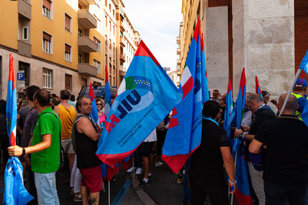 Trieste, Italy - September 03, 2022: Protesters with flags from the Italian UIL and UILM Union during the demonstration against the layoffs of workers from the Wartsila group.のeditorial素材