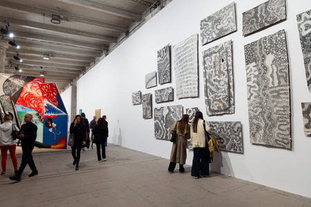 Venice, Italy - April 17, 2024: Visitors looking the Artwork by Naminapu Maymuru-White titled Stars...